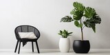 Fototapeta  - Nordic-style interior with a white chair in a white room, a plant on a stool, and black & white pouffes.