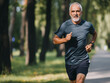 © ver0nicka - happy middle-aged man exercising, running in the park, living a healthy lifestyle