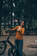 © ARMMY PICCA - Happy young Asian woman while riding a bicycle in a city park. She smiled using the bicycle of transportation. Environmentally friendly concept.