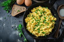 Top View Of Scrambled Eggs In A Frying Pan With Pork Lard Bread And Green Onions