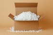 © LimeSky - White foam packing and polystyrene on beige backdrop in a cardboard box