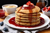 Fototapeta Do przedpokoju - Stack of pancakes with strawberry and apricot jam on a plate