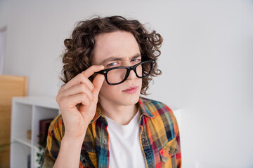 Poster - Photo of suspicious unsure guy dressed checkered shirt arm eyewear suspiciously looking you indoors house home room