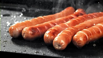 Poster - Sausages are fried with splashes in a pan. Filmed on a high-speed camera at 1000 fps. High quality FullHD footage