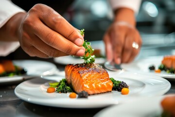 Wall Mural - Close-up of a chefs hands adding a garnish to a salmon dinner plate. 