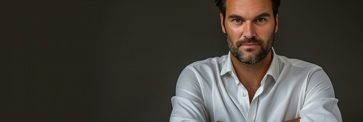 Wall Mural - portrait of a handsome businessman in white shirt, hands folded, grey background with copy space