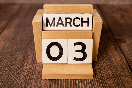 3 Marz on wooden grey cubes. Calendar cube date 03 March. Concept of date. Copy space for text or event.