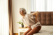 © Dusan Petkovic - A senior woman is having backache and trying to get up.