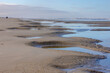 Landscape of wide and long beach, White sand with puddle or pond water under blue sky, The Dutch Wadden Sea island Terschelling, A municipality and an island in the northern, Friesland, Netherlands.