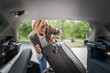 © Miljan Živković - mature blonde woman travel take stuff belongings from the back of car