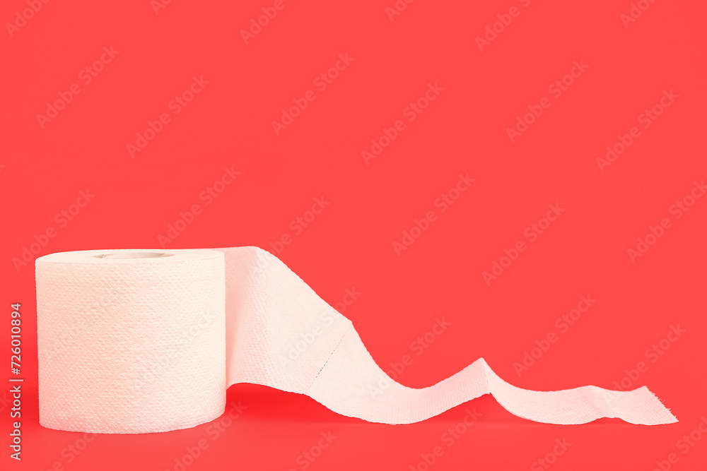 Roll of toilet paper on red background