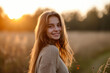 © MagnusCort - A woman in a sweater is smiling and looking at the camera