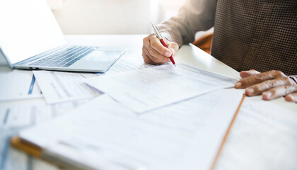 Wall Mural - Asian businessman reviewing document reports at office workplace with computer laptop. legal expert, professional lawyer reading and checking financial documents or insurance contract before sign