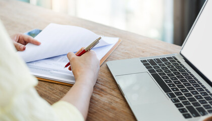 Wall Mural - Close-up shot, young female lawyer working with laptop reading and checking financial documents or insurance contract before sign