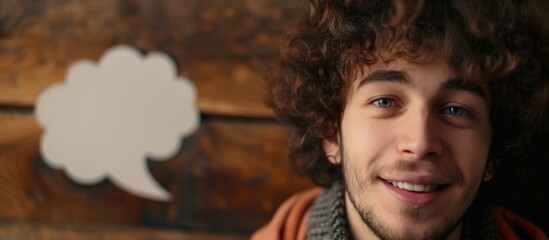 Wall Mural - Curly-haired man with speech bubble in close-up.