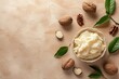 Top view of unprocessed shea butter on a beige background showing nuts and leaves with empty space for copying