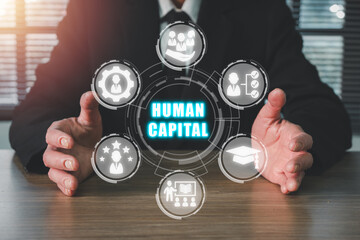 human capital concept, businessman hand holding human capital icon on virtual screen. production pro