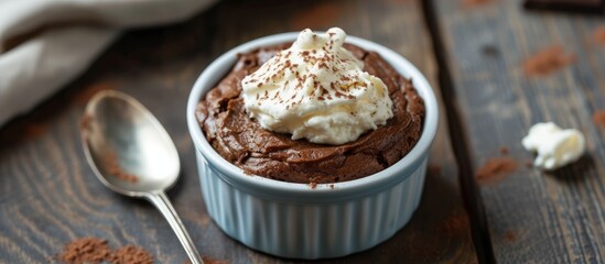 Wall Mural - Chocolate cake with cream cheese, served in a ramekin and eaten with a spoon.