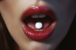 close-up photo of a woman's mouth, her mouth is wide open, on her tongue there is a pill