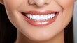 © Ameer - Young woman with perfect white teeth smiling happily at the dentist. Oral hygiene and dental care concept. Stomatology and dentistry background.