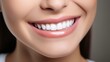 © Ameer - Young woman with perfect white teeth smiling happily at the dentist. Oral hygiene and dental care concept. Stomatology and dentistry background.