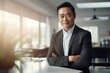 © Iona - Confident Asian businessman in office setting