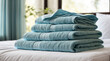 Clean towels on white bed, copy space.