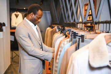 Wall Mural - Young african man shopping in clothing store