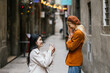 Woman proposing to her girlfriend outdoors on the street.
