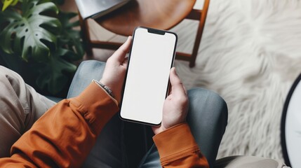 Wall Mural - Top view mockup mobile phone Man sitting and holding blank screen. generative AI