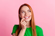 Photo of dreamy woman with ginger hair dressed green t-shirt look at offer empty space finger on teeth isolated on pink color background