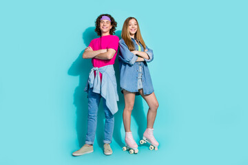 Wall Mural - Full length photo of two happy teenagers spend time together folded arms wear roller skates and retro look isolated on cyan color background