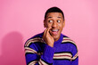 Photo of funny sly guy dressed striped pullover arm mouth telling rumors looking empty space isolated pink color background