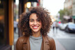 © Klemenso - a cheerful woman smiles on the city streets. Her trendy style and vibrant demeanor reflect a joyous urban lifestyle
