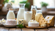 A variety of dairy products including yogurt, milk, and cheese arranged on a kitchen countertop.