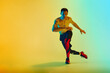 © master1305 - Shirtless male athlete in mid-action with focused expression training shirtless against gradient blue yellow background in neon. Concept of active and healthy lifestyle, sport, fitness, endurance
