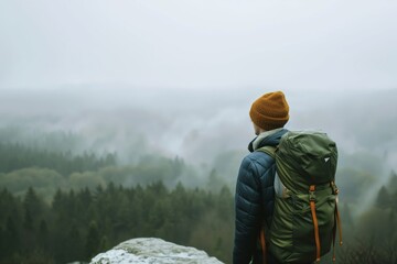 Wall Mural - hiker looking at view from misty mountain top