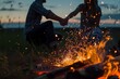 man and woman holding hands across a campfire with sparks flying