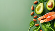© Kowit - Top view of a nutritious meal setup with sliced avocado, raw salmon, almonds, and fresh spinach leaves on a green background.