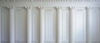 White plaster columns and pilasters on a gypsum backdrop.