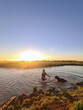 © Austockphoto - Teen boy and his dog swimming in dam at sunset. Summer life on the farm.