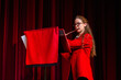 © Austockphoto - Female flautist playing solo performance on flute at concert