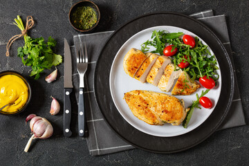 Canvas Print - fried chicken breasts with green salad on plate