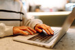 © maxbelchenko - Close-up of hands working on a laptop keyboard. Concept of using the Internet and modern wireless technologies