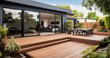 Home's Modern Extension Featuring a Chic Deck, Inviting Patio, and Serene Courtyard