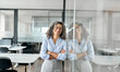 © insta_photos - Happy older mature professional business woman standing in office, portrait. Smiling confident middle aged female corporate leader, senior lady executive manager arms crossed looking at camera.