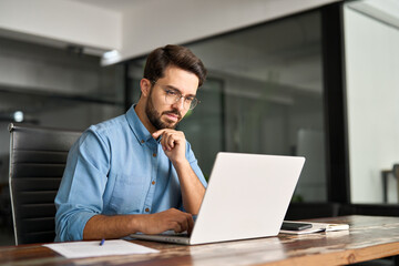 busy professional business man company employee, young male programmer, latin businessman looking at