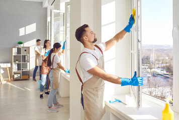 Wall Mural - Male cleaner and group window washing, working, professional janitor service busy completing cleaning tasks at home, office. People employed to take care of room, small company maintaining apartment 