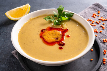 Delicious lentil soup on vintage background