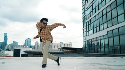 Wall Mural - Happy hispanic dancer wears casual outfit break dancing at urban city. Energetic hip-hop performance. Choreographer move along the freestyle beat. Hip hop dancing. Outdoor sport 2024. Endeavor.